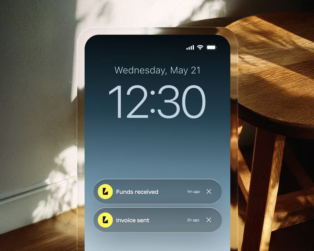Phone lock screen with Lodgify Funds received and Invoice sent notifications